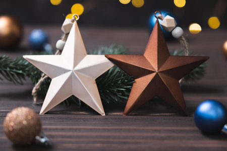 Winter background with fir branches and Christmas decorations in form of stars