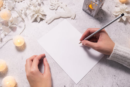 Goals plans dreams, make to do list for New Year. Woman hands holding pencil on empty paper....