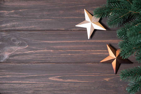Winter background with fir branches and Christmas decorations in form of starの写真素材