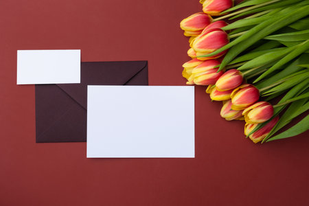 Blank Clean minimal business card mockup and elegant greeting card with bouquet of tulipsの写真素材