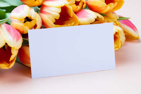Clean minimal business card mockup with bouquet of tulipsの写真素材