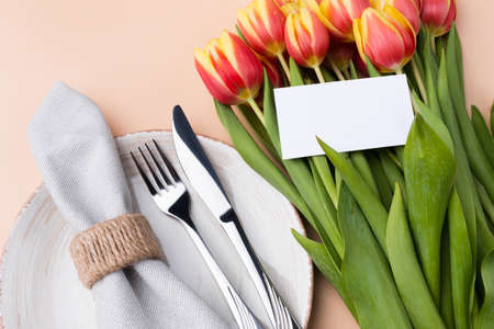 Elegantly holiday dinner table. Festive table setting at neutral beige color top view.の写真素材