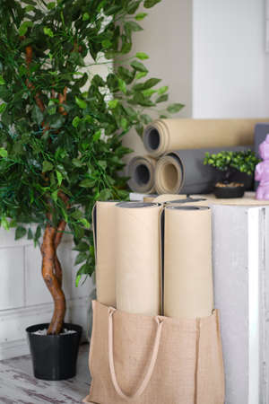 A set of sports equipment in the yoga room. Rolled mats for yoga, meditation or fitness.の写真素材