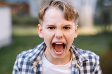 Portrait of an annoyed teenager screaming looking at the camera