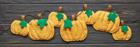 Ready-made garland of decorative felt pumpkins for home decoration. Autumn or Halloween decorの写真素材