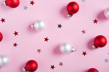 Creative holiday pattern. Christmas background of red and white baubles on a pink background.の写真素材