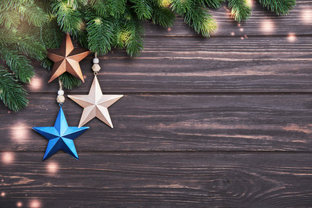 Christmas or New Year background with fir branches and decorations in form of starの写真素材