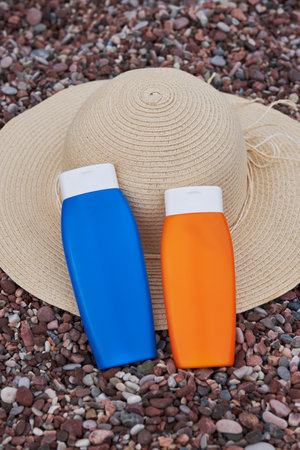 Templates of tubes of sunscreen lotion or sunblock cream and hat. Spf uv-protect cosmetic products.の写真素材