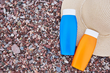 Templates of tubes of sunscreen lotion or sunblock cream and hat. Spf uv-protect cosmetic products.