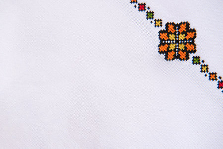 Folk Embroidery on White Linen. Background with Fabric Texture and Embroidered Ornament Element.