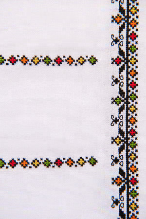 Element of Handmade Embroidery on White Linen by colored Cotton Threads. Craft embroidery. Design of ethnic pattern.の写真素材