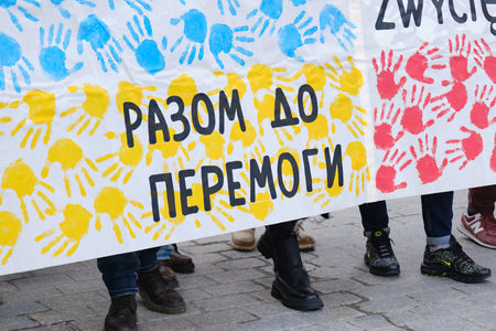 KRAKOW, POLAND - FEBRUARY 24, 2024: Posters with the Slogan Together To Victory in the Hands of...