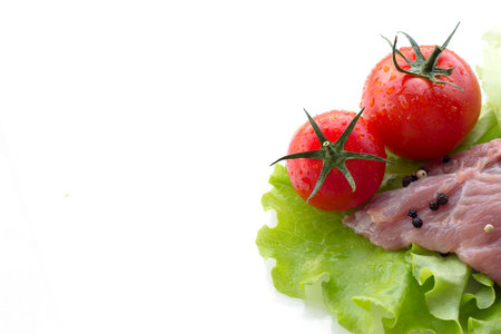 piece of raw meat and vegetables isolated on white background