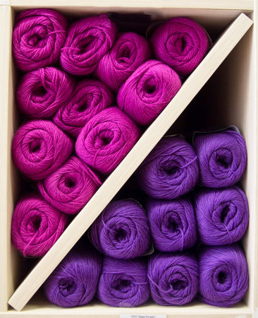 many colored threads laid out in the shelf