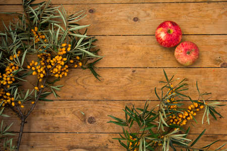 ripe yellow sea-buckthorn berries on wooden backgroundの写真素材