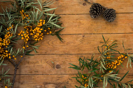 ripe yellow sea-buckthorn berries on wooden backgroundの写真素材