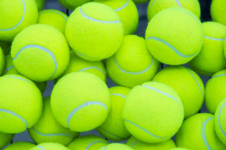 lot of bright yellow tennis balls as a backgroundの写真素材