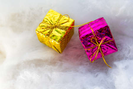 brightly colored gift boxes on wooden background, top view, new year and Christmas. Bright shade giftの写真素材