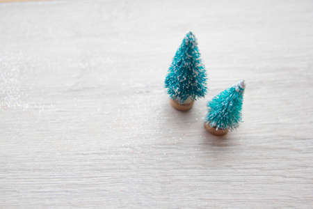 Artificial christmas trees with snow and gift boxes for background with copy space - shallow depth of fieldの写真素材