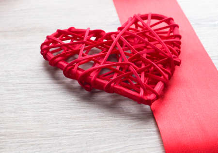 red wicker heart and red satin ribbon concept of love and Valentines dayの写真素材