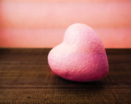 one pink heart on wooden background, concept of Valentine day, space, the substrateの写真素材