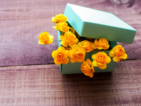 Vintage background with a gift and flowers on a wooden surface
