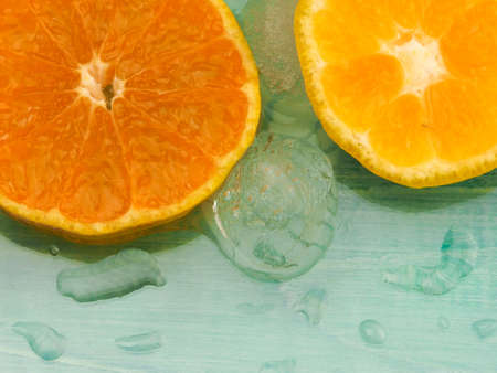 Fresh orange macro in ice cubes background.の写真素材
