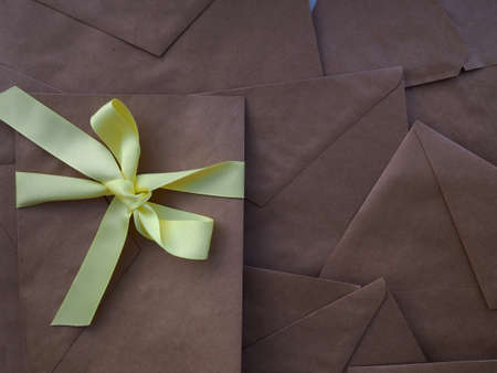 many envelopes from Kraft paper, old paper as a background, in full, space for text, background, book coverの写真素材