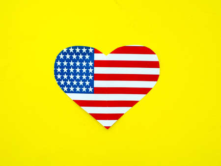 American flag in the shape of a heart on bright yellow background, USA, independence dayの写真素材
