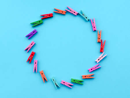 many colored clothespins on a blue background, as a substrate, pin clothes pegの写真素材