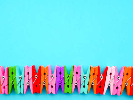 many colored clothespins on a blue background, as a substrate, pin clothes pegの写真素材