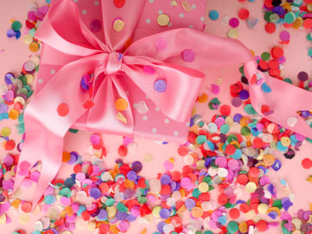 gift box and flying confetti, holiday atmosphere, on a blue and pink backgroundの写真素材