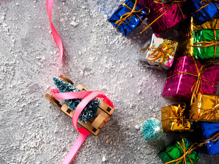 Christmas concept, toy santa sleigh, gift boxes on snow and blur bokeh, Empty wooden sled