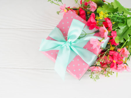 Small gift box decorated with ribbon and flower, Beautiful romantic gift box on wood.