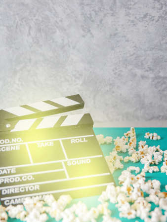 Popcorn and clapperboard on colorful blue backgroundの写真素材
