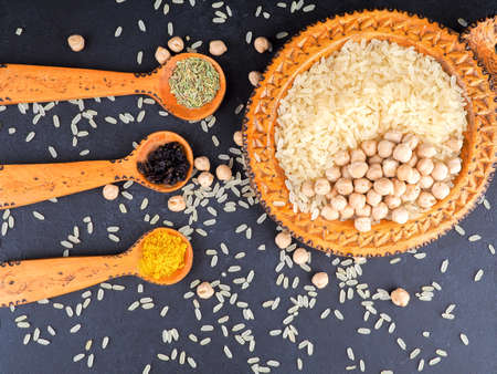 Asian cuisine and spices, rice, chickpeas and turmeric on a plate.の写真素材