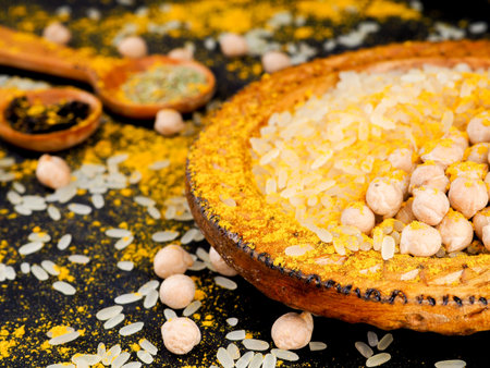 Asian cuisine and spices, rice, chickpeas and turmeric on a plate.の写真素材