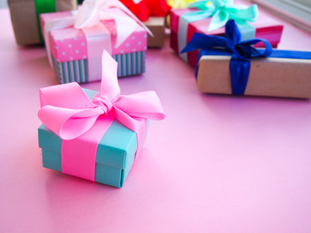 funny gift boxes on pink background, the concept of gift for the holiday.