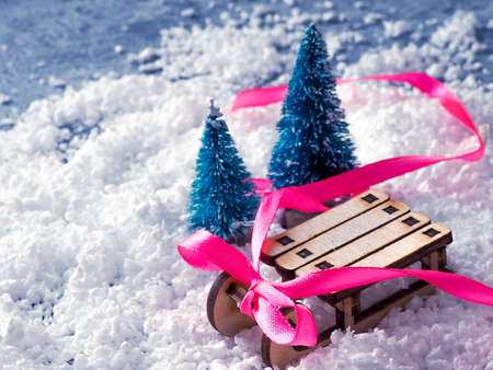 Christmas background. Christmas trees and sleighs, ribbons and Christmas gifts.の写真素材