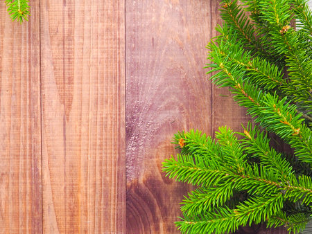 Christmas tree branches on wood background. fir branches wood table