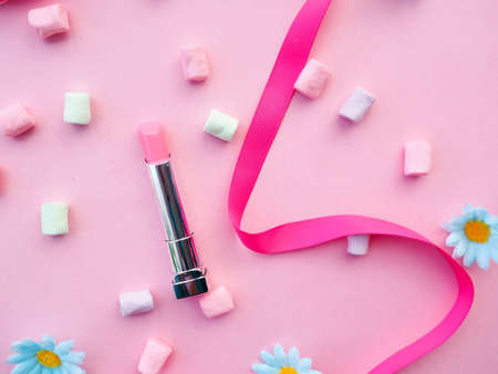 Many cosmetics on pink background, brush, lipstick ribbonの写真素材