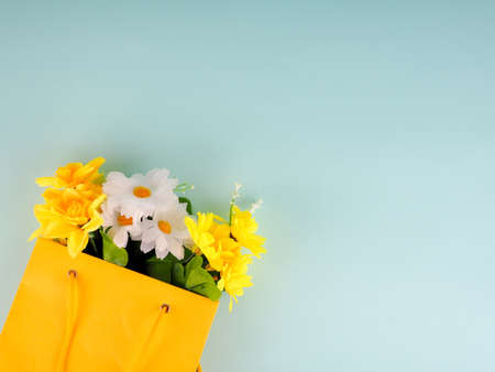 flowers in the package on blue background, space for text.の写真素材