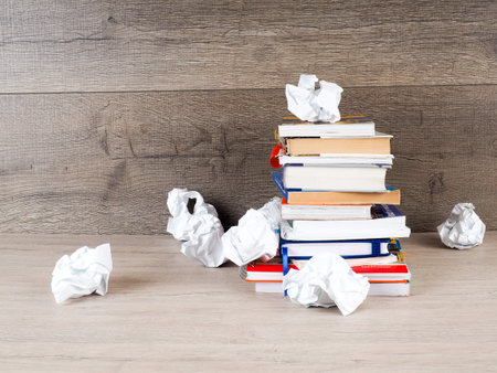 stack of books, crumpled paper, student preparing for exams, Cup of coffee