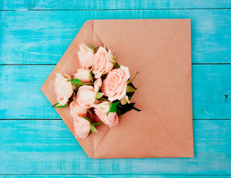 Envelop with white card and rose background. Top view., Envelope with flowers summer, springの写真素材