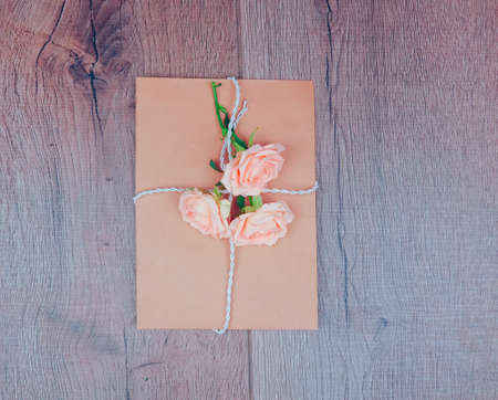 Envelop with white card and rose background. Top view., Envelope with flowers summer, springの写真素材