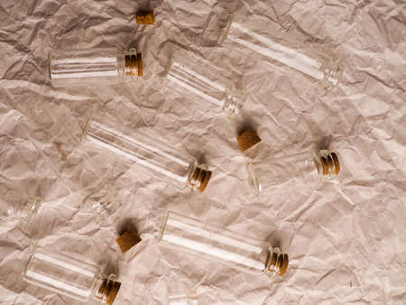 many small glass bottles used in medicine on paper background.の写真素材