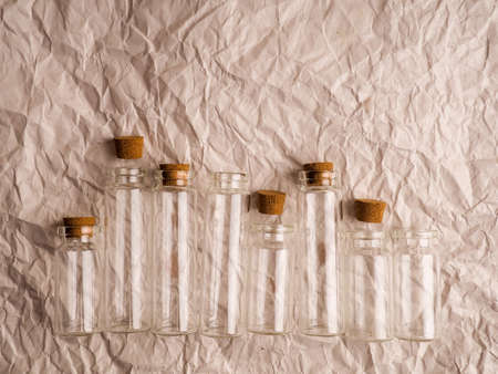 many small glass bottles used in medicine on paper background.の写真素材