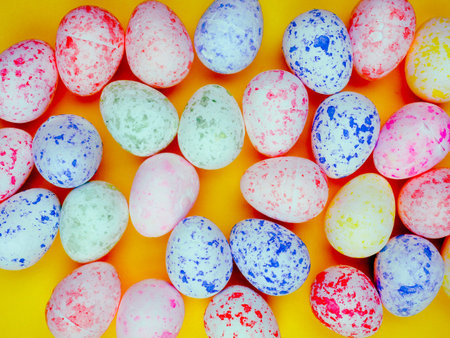 colored eggs for Easter on a bright yellow background, copy space for text, sun