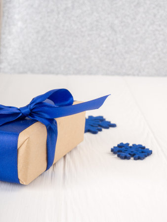 Gift boxes wraped in recycled paper with ribbon bow and snows.の写真素材