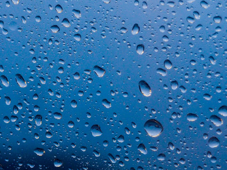 Water drop on the glass of windows background, raining on the glass off window city for background